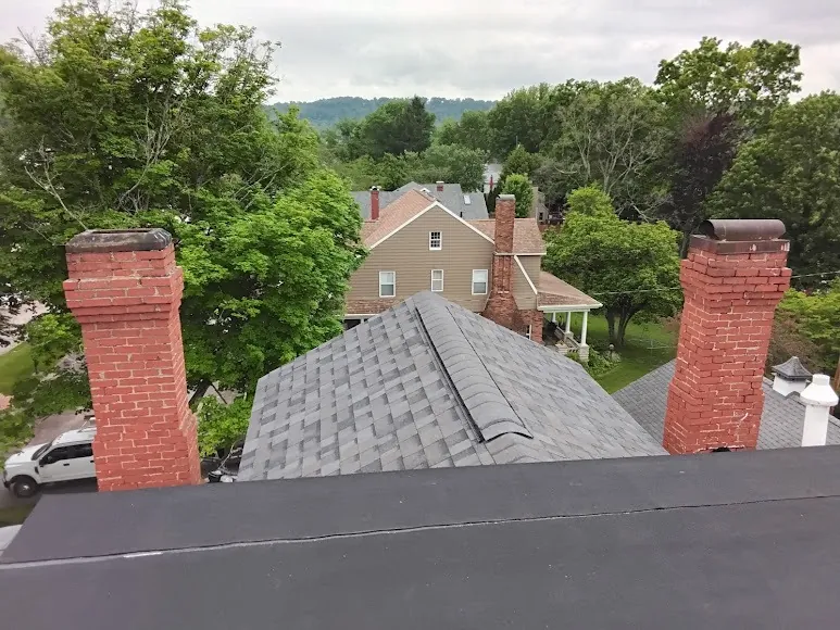 Brick chimneys on a shingle roof, a common spot for roof leaks