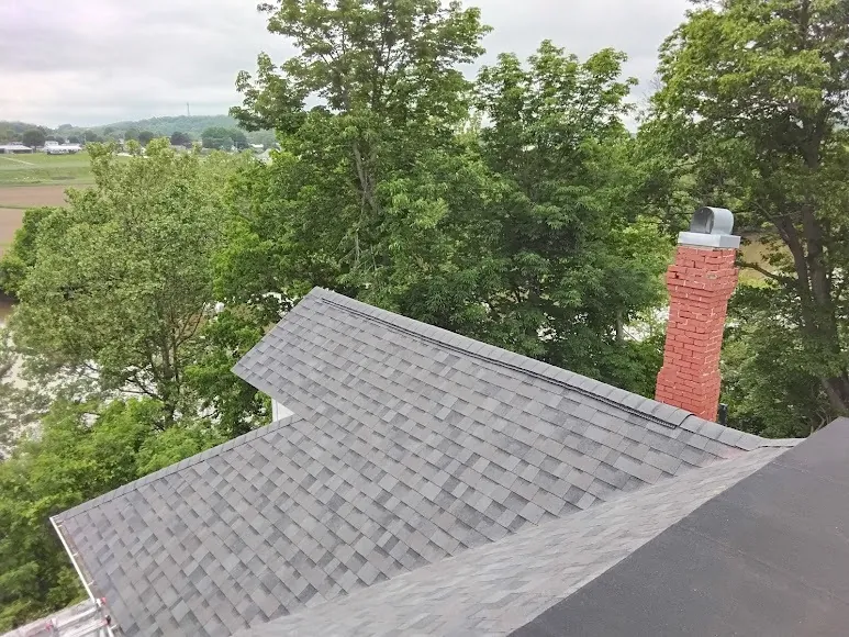 Chimney on a newly shingled roof, sealed with new flashing