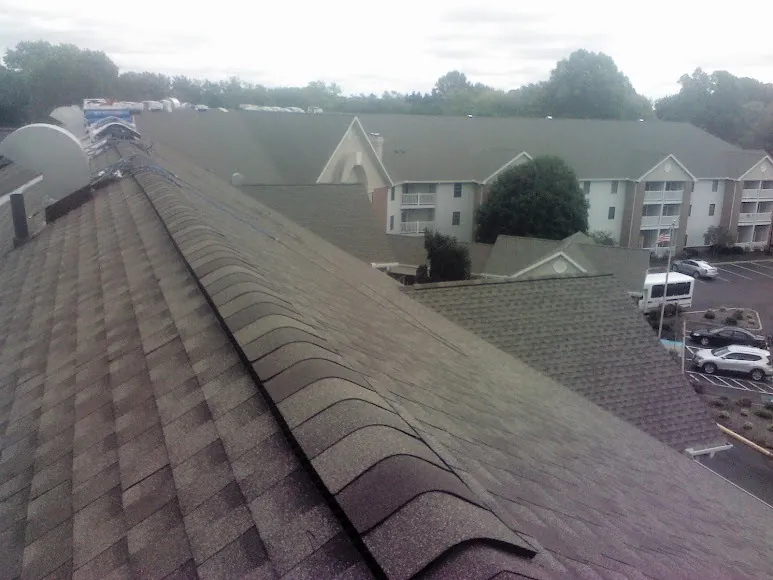 Newly repaired shingles along a roof ridge
