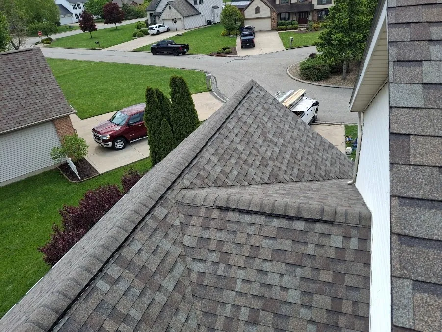 Missing and damaged shingles on a roof after a storm